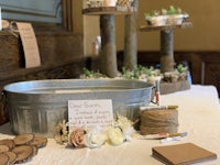 a table with a bucket of flowers and a sign