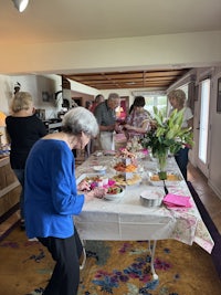 a group of people standing around a table