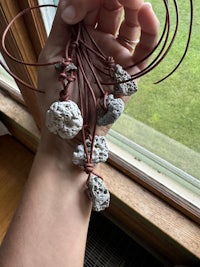 a person holding a bunch of rocks in their hands