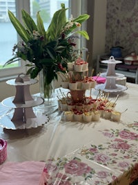 a table with a pink and white tablecloth