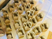 a table full of cupcakes in brown paper bags