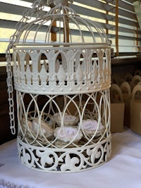 a white birdcage is sitting on a table