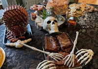 a table full of food and skeletons