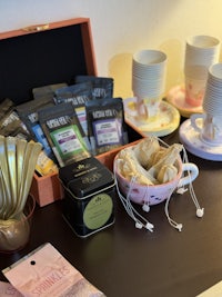 a table with tea cups and tea bags on it