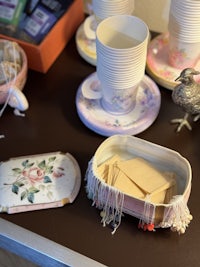 a table with cups, plates, and other items on it