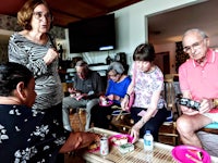 a group of people sitting around a table eating food